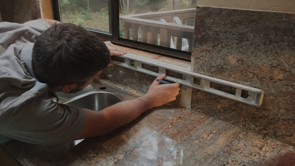 man measuring for a kitchen remodel