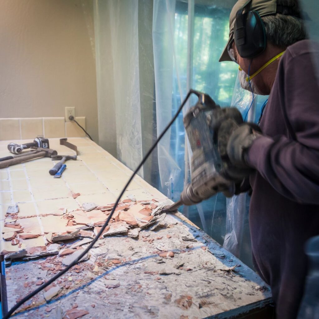 Contractor ripping up tile countertops