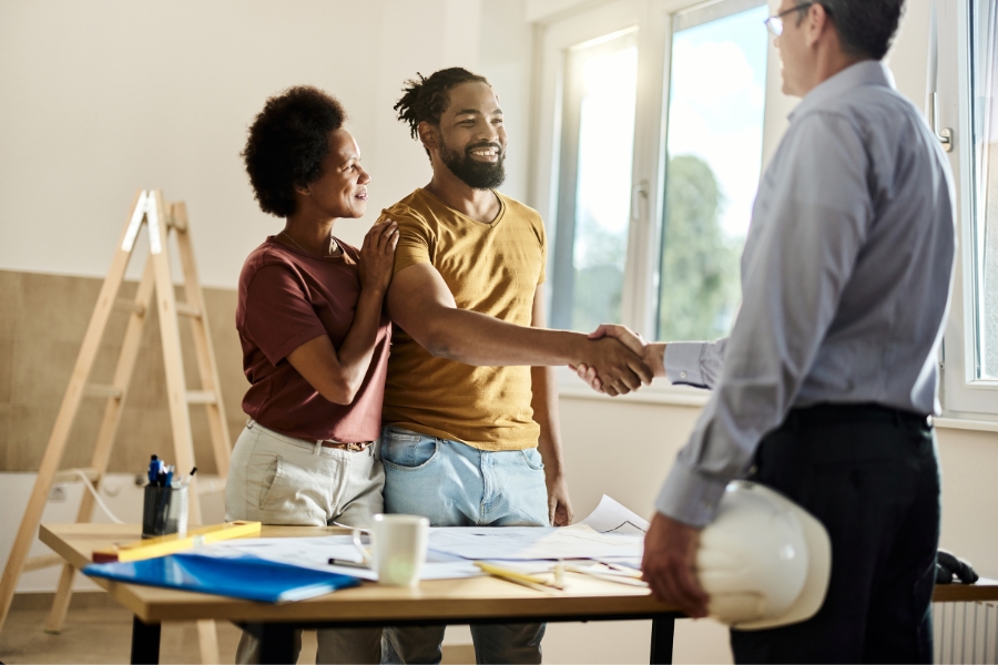 A couple happily speaking with renovation expert