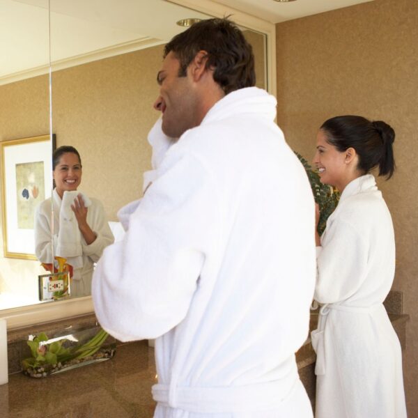 couple getting ready in double vanity bathroom