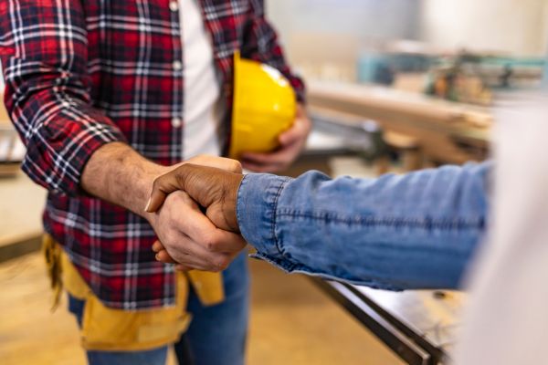 Contractor shaking hands with customer