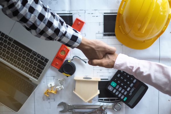 Contractor shaking hands with client