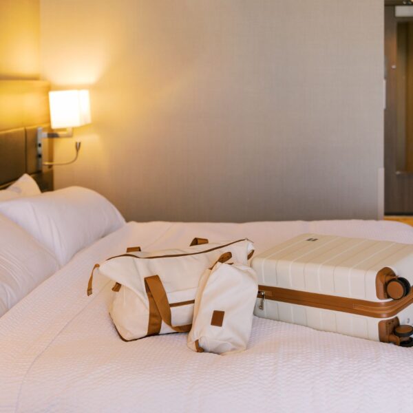 luggage on queen bed