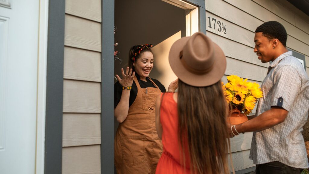 person greets guests at door