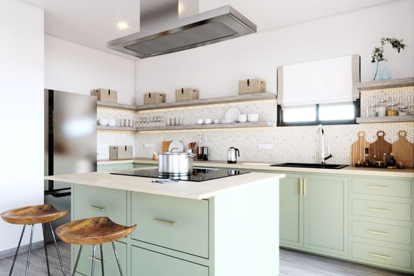 Contemporary kitchen design with light green cabinets, open wood shelving, and a stainless steel island ventilation hood.